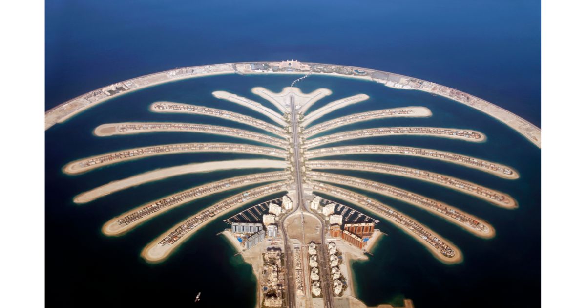 Aerial view of the Palm Jumeirah in Dubai, showcasing its iconic palm tree-shaped design extending into the sea.