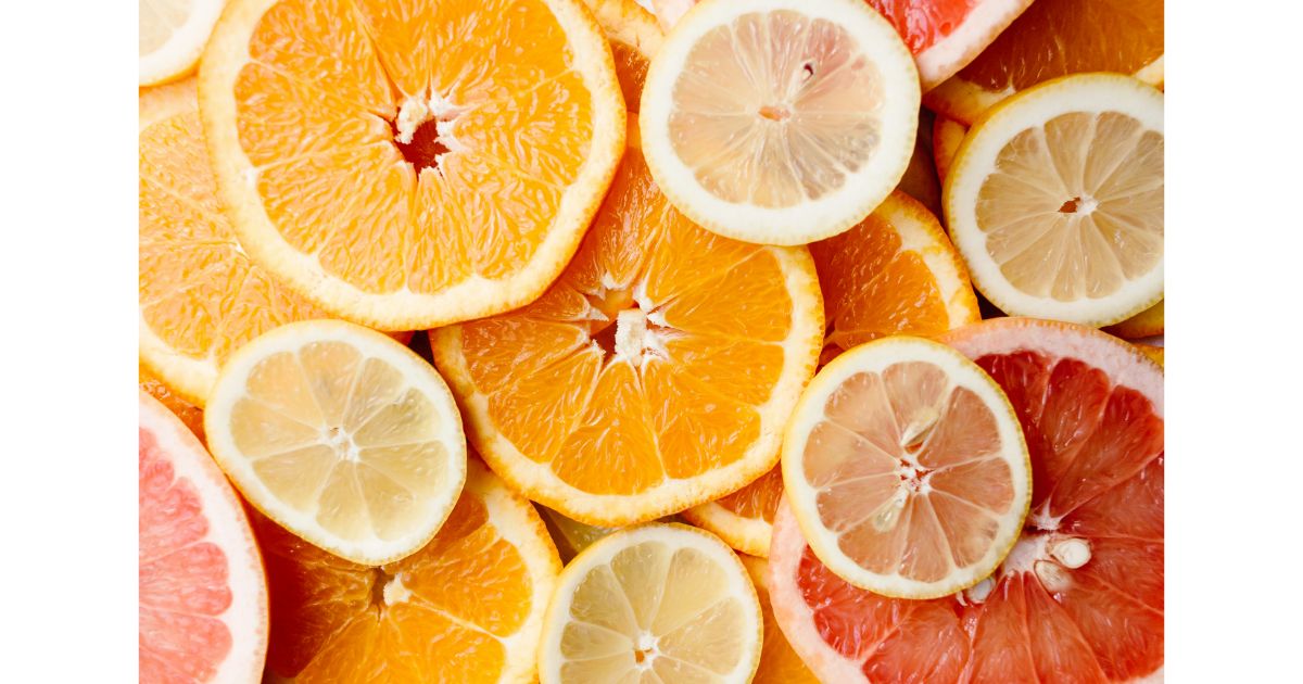 Close-up of various citrus fruits including orange, lemon, and grapefruit slices arranged together.