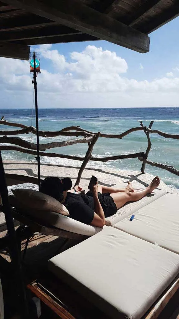 Woman sunbathing while using Viva Wellness IV Drip 