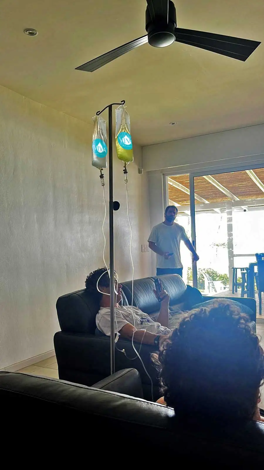 Three Men sitting on the couch while using Viva Wellness IV Drip
