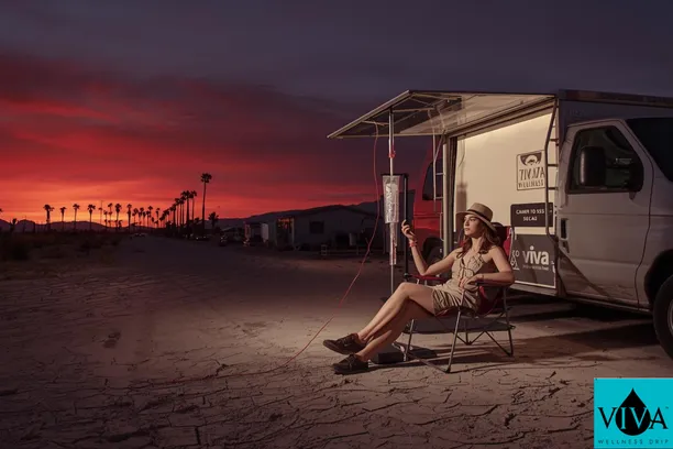 Festival-goer receiving Mecca CA IV drip therapy from Viva Wellness before heading to Coachella grounds