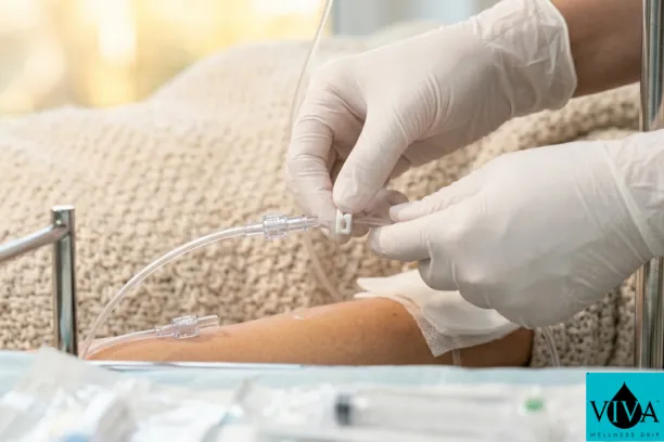 A professional nurse ensuring a safe mobile IV drip experience to minimize side effects like bruising.