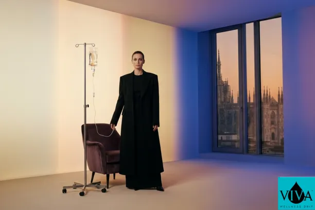 A luxury mobile IV therapy setup in a modern Milanese suite featuring a professional drip bag and designer furniture, with the Milan Duomo visible in the background during Milan Design Week 2026.
